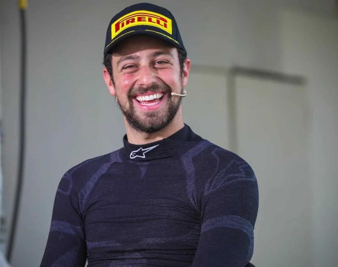 Carl Rizk smiling in his race suit