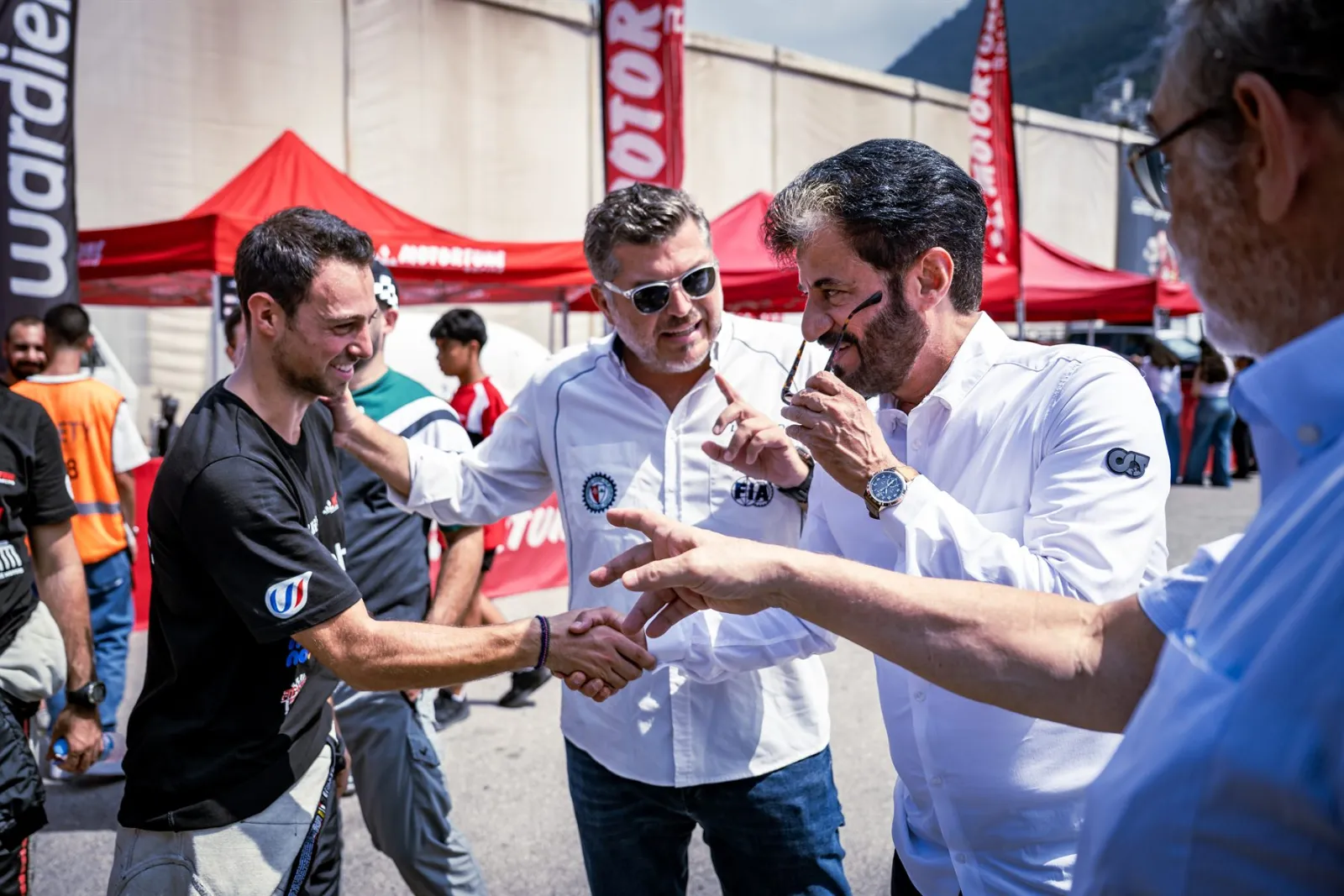 Carl Rizk shaking hands in the service park