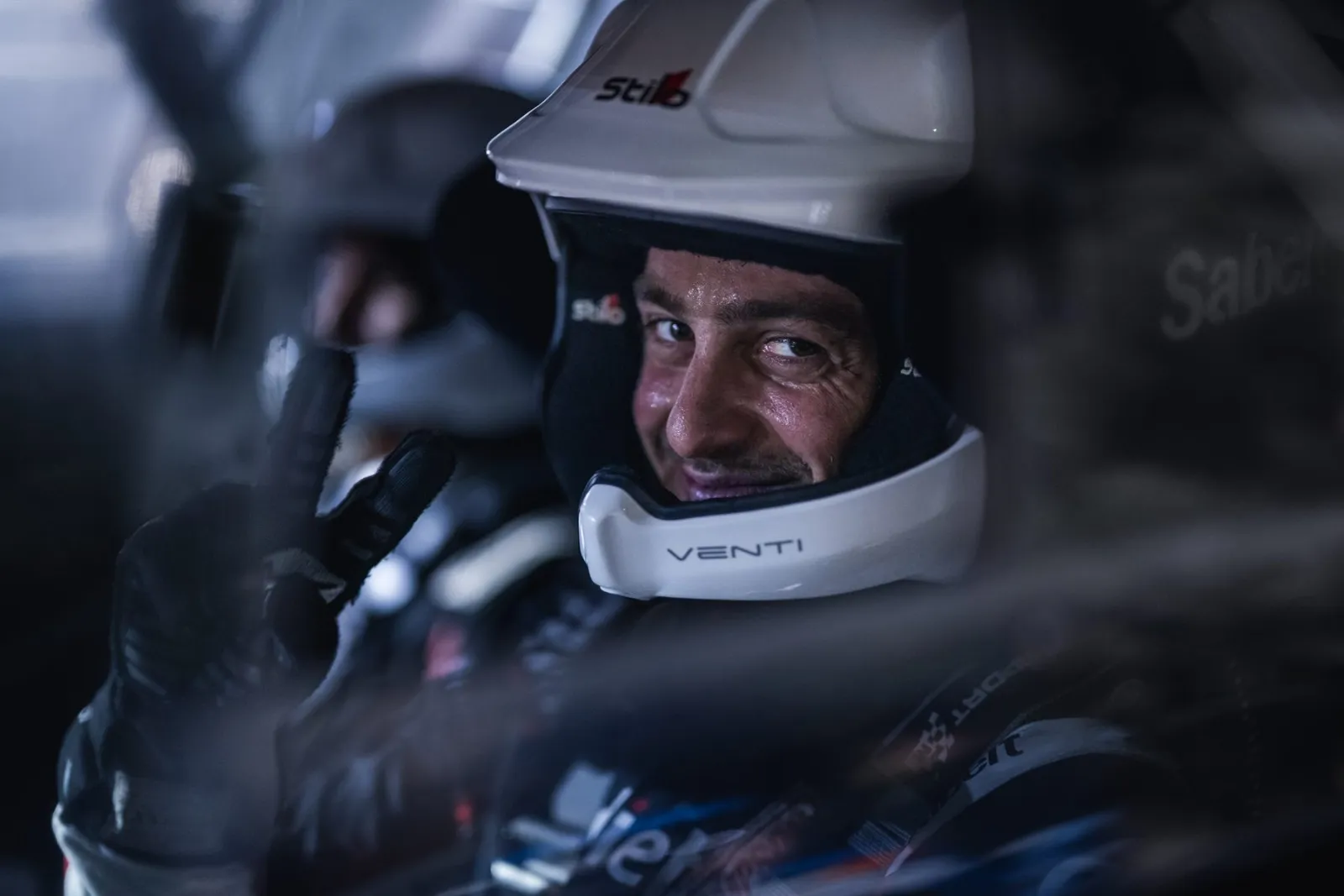 Carl Rizk in the car, helmet on