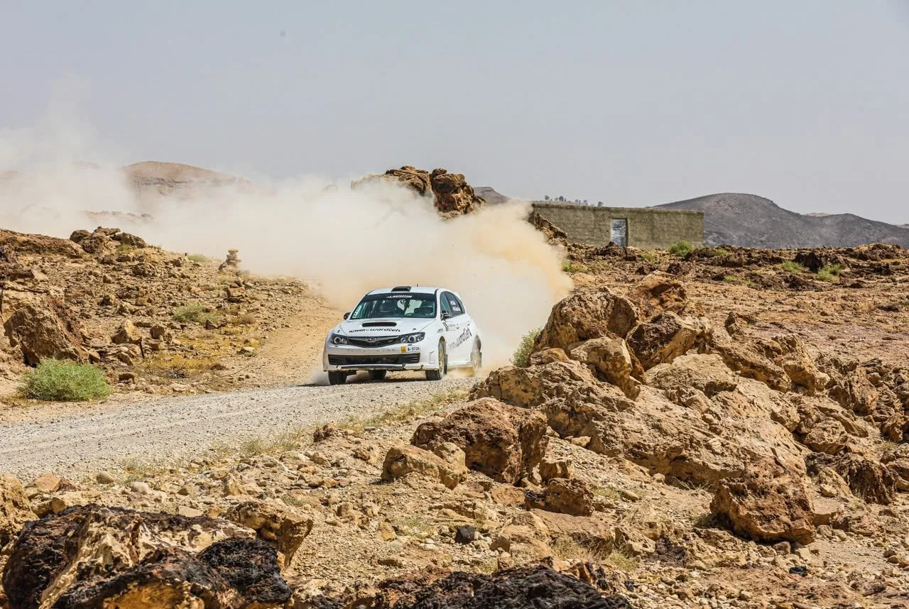 The Subaru trailing dust through the Jordanian desert